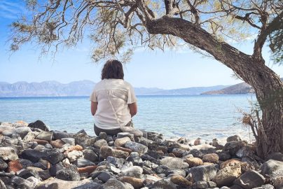 A person sits and enjoys the scenic seaside view.