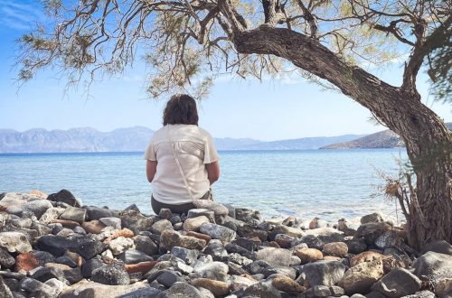 A person sits and enjoys the scenic seaside view.