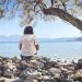 A person sits and enjoys the scenic seaside view.